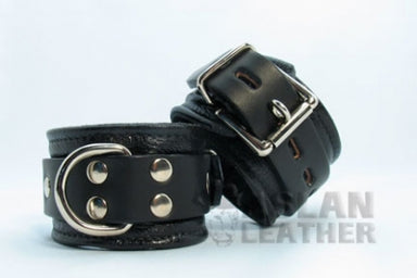Black leather cuffs on white background