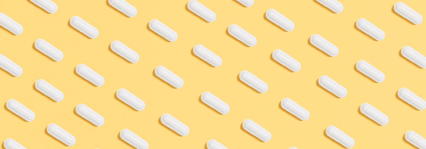 Pills in diagonal lines on a yellow background