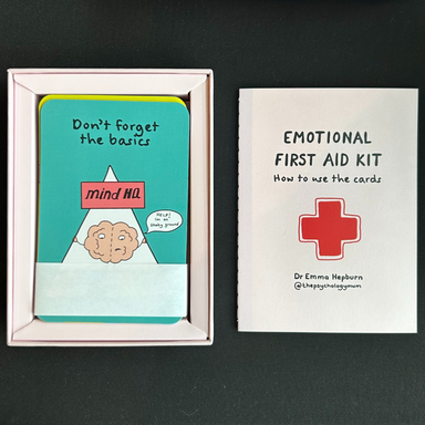 A look at the contents, a book that is titled "how to use the cards" and one of the cards that says "don't forget the basics" with a drawing of a brain. 