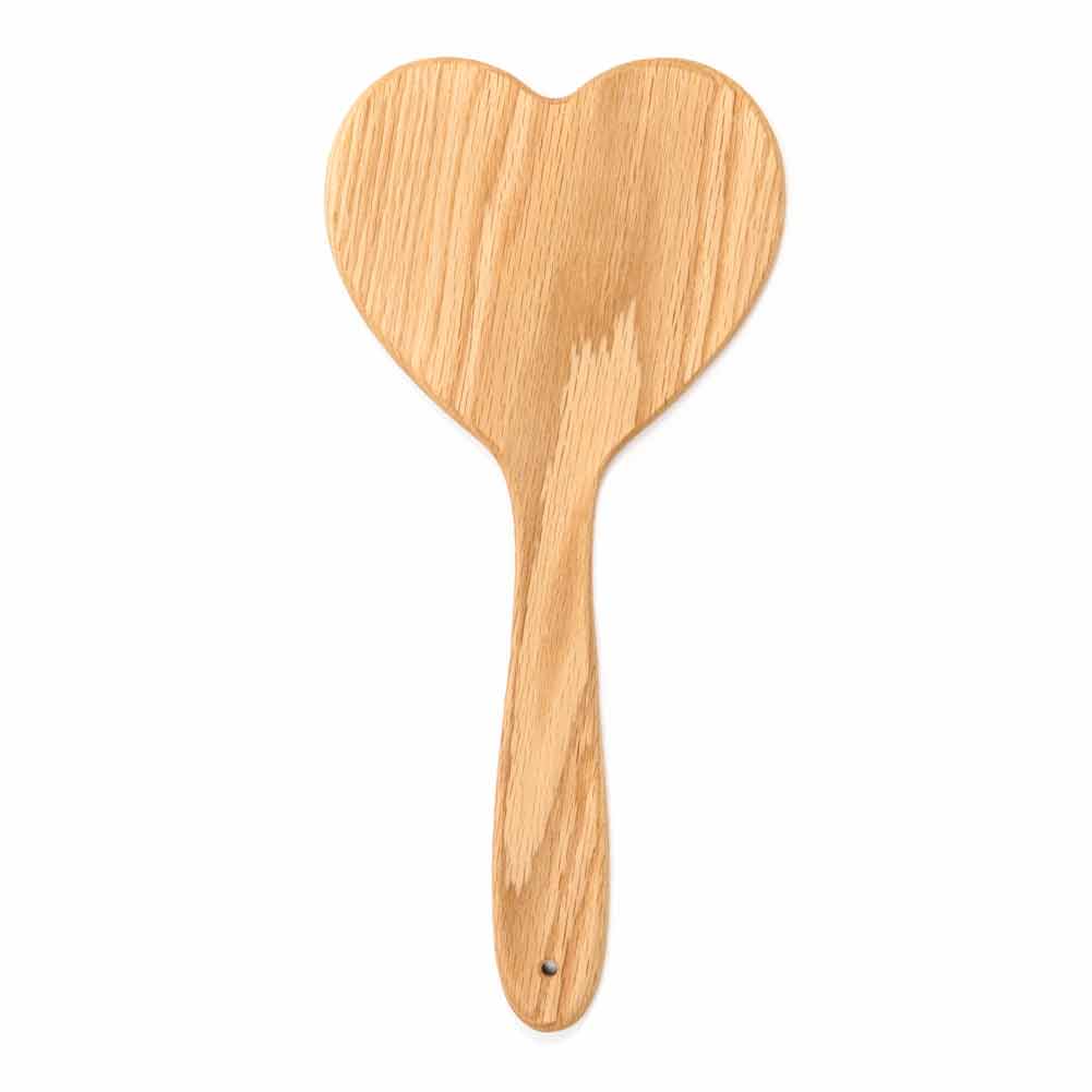 Wooden heart-shaped paddle on a white background