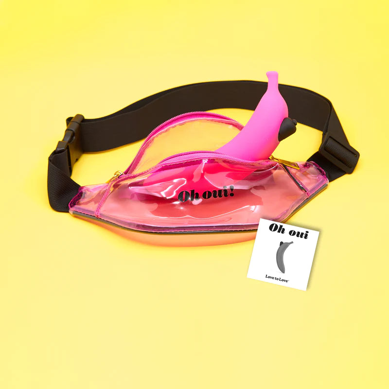 The banana dildo is pictured peeking out of a see-through, pink fanny pack with the words "Oh Oui!" on the front. 