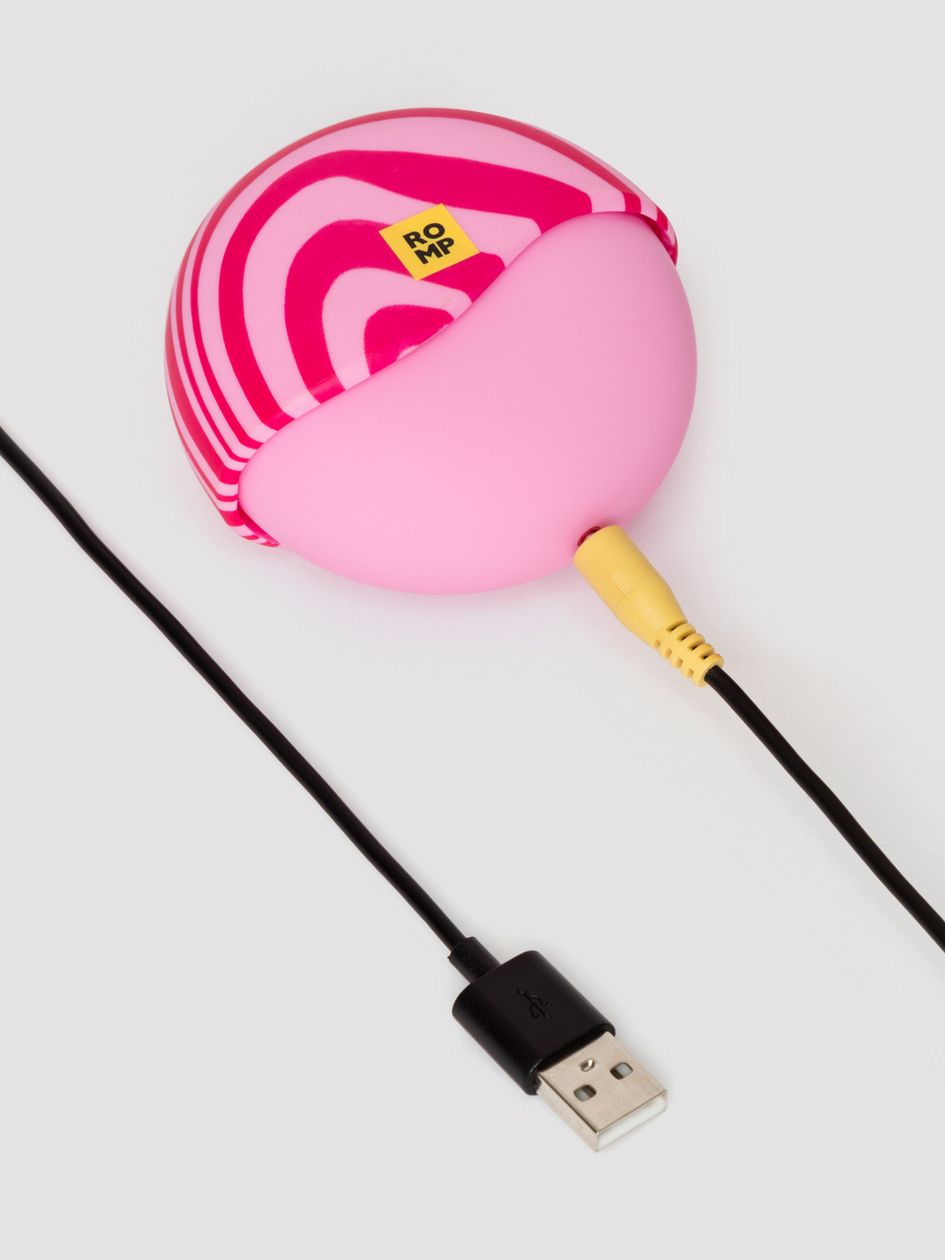 ROMP Spin with its charger plugged in to the base of the toy