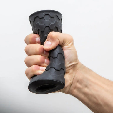 Blush Hekx Silicone Stroker gripped in a fist