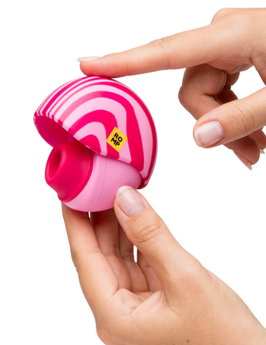 The ROMP Spin being held up to show the case closing around the front of the toy.