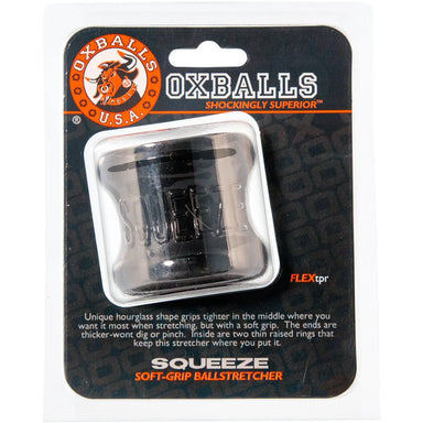 The packaging for oxballs squeeze. The Logo for Oxballs U.S.A. is in the top left corner, and text under the toy reads "Unique Hourglass shape grips tighter in the middle where you want it most when stretching, but with a soft grip. The ends are thicker - won't dig or pinch. Inside are two thin raised rings that keep this stretcher where you put it." 