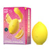 ROMP lemon crush toy pictured next to it's packagine, a bright pink and yellow box. On the box is the toy, a real lemon, and the words "ROMP Lemon Crush, meant to be, clitoral stimulator"