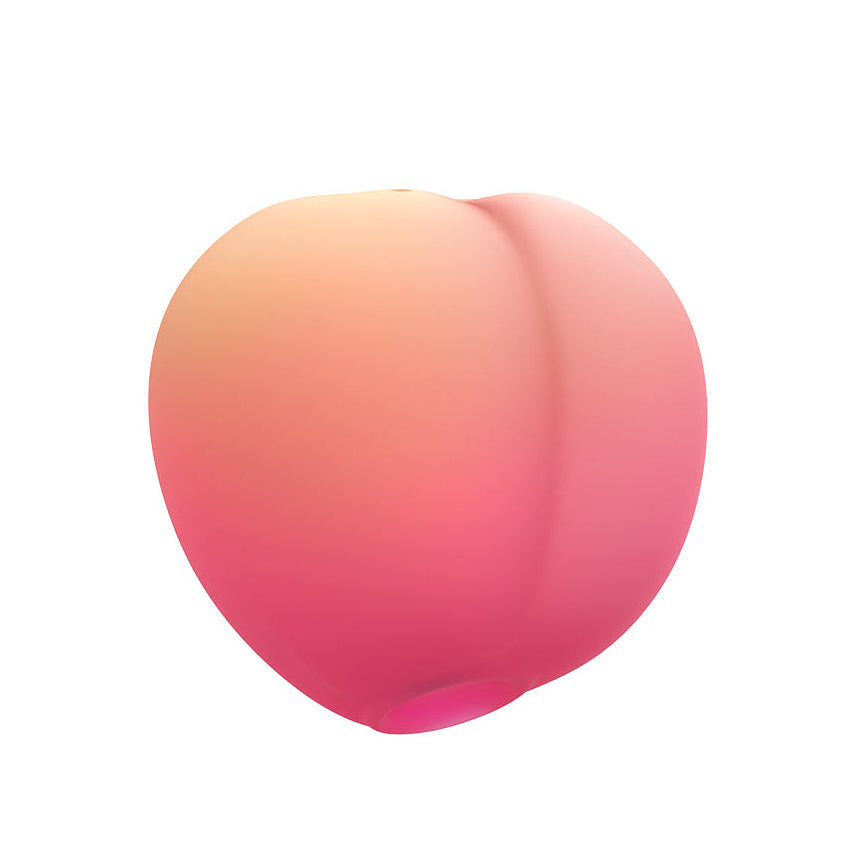 A peach shaped air pulse toy against a white background 