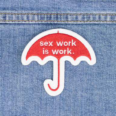 A red umbrella patch with the words sex work is work in white embroidery