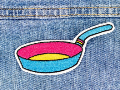 A frying pan patch in the vibrant colours of the pansexual flag 