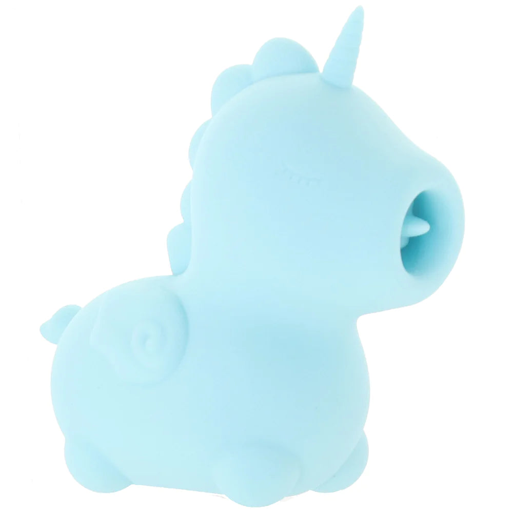 The side view of the unicorn-shaped toy. The toy is a simply-designed unicorn shape with a small wing on the side, a tail, a bumpy mane, a horn, and a closed eye with eyelashes. The mouth has a hole with a tongue mechanism that flicks up and down when turned on.
