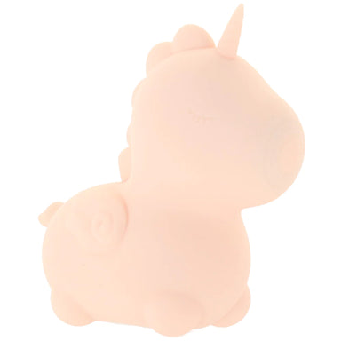 The side view of the unicorn-shaped toy. The toy is a simply-designed unicorn shape with a small wing on the side, a tail, a bumpy mane, a horn, and a closed eye with eyelashes. The mouth has a round plate that pulses when turned on.