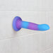 Rave dildo suction-cupped onto wall