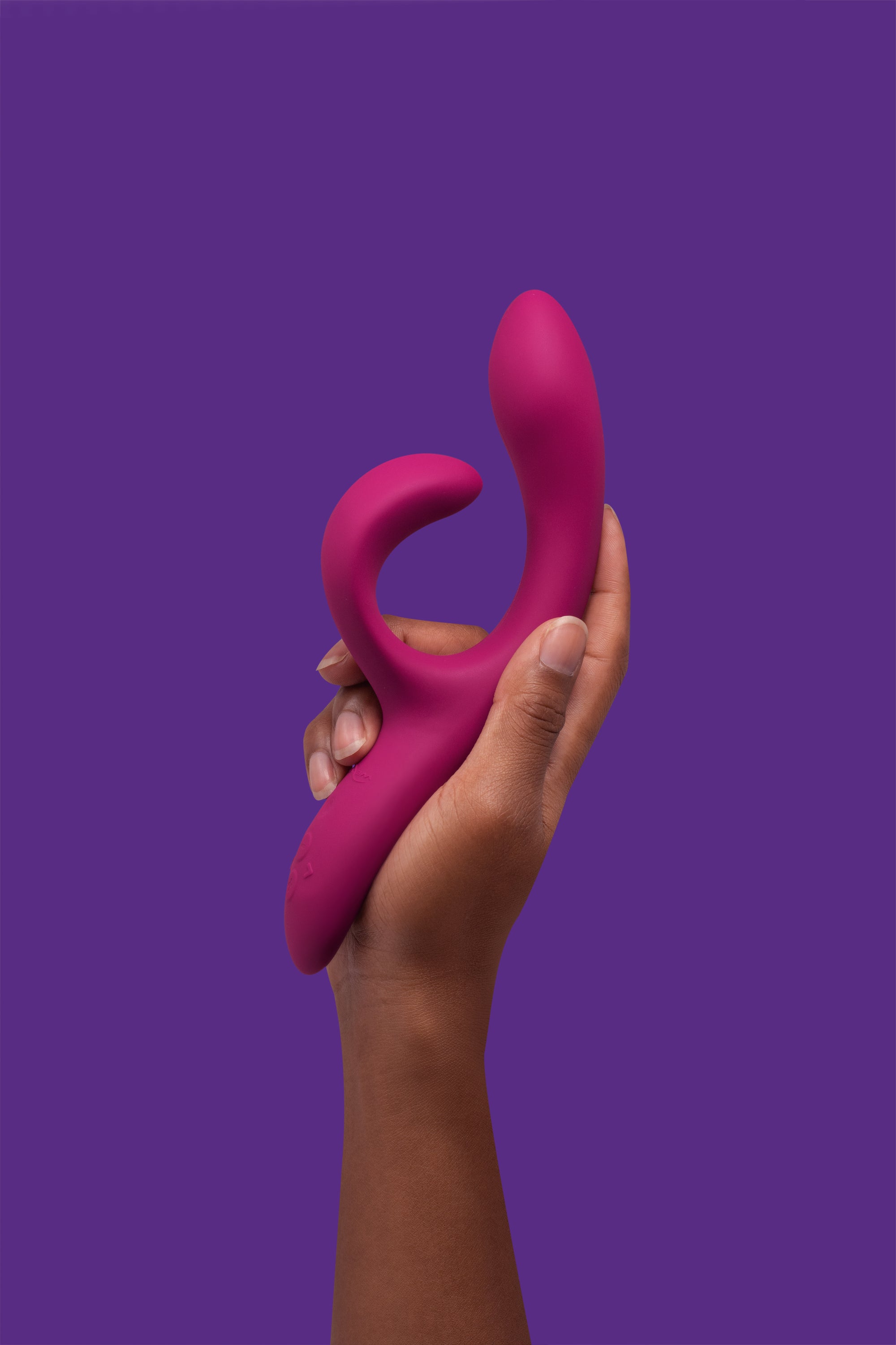 We-Vibe Nova 2 held in hand with purple background