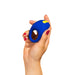 HAnd holding a blue Romp Juke c-ring against a white background