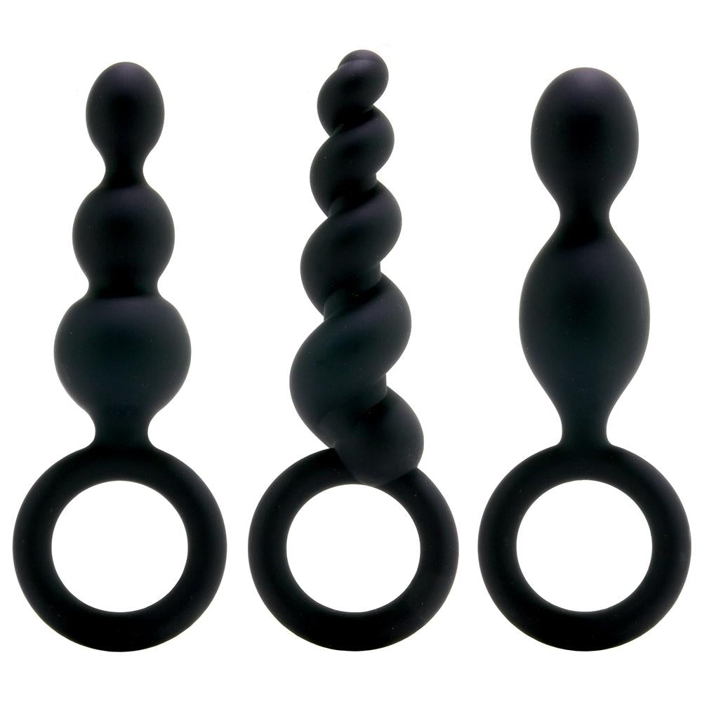 Three black butt plugs on a white background