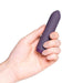 hand holding purple bullet vibrator diagonally