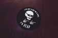 A black circular iron-on patch with the words "I'm not a boy or a girl" at the top and "I'm Dead" at the bottom. In the centre of the patch is a skull wearing sunglasses and two skeleton hands giving the "finger guns" motion. 