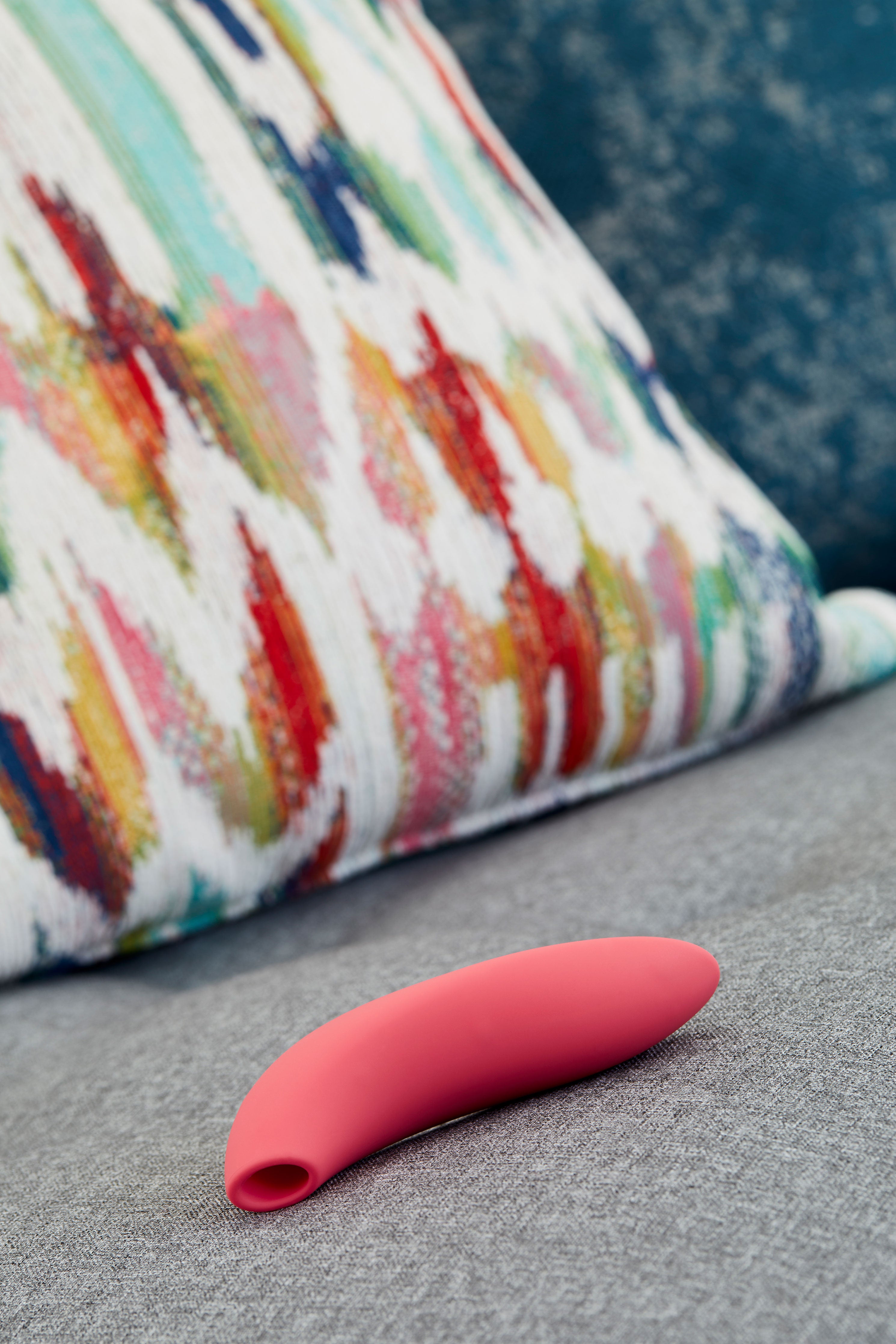 We-Vibe Melt in front of colorful pillow