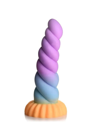 Mystique Unicorn dildo standing up, it has violet and blue swirls down the shaft and a wide yellow base.