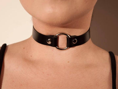 Black collar worn on person's neck