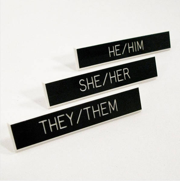 Three pronoun pins placed next to each other